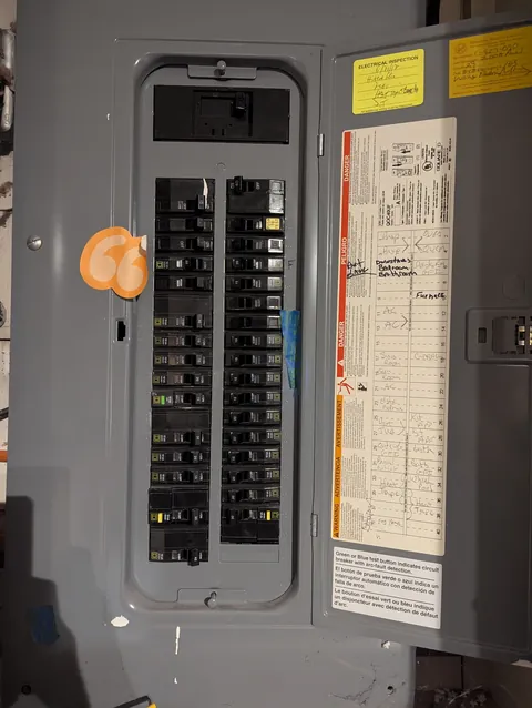 New 200 amp electrical panel with the door open and a labeled circuit directory