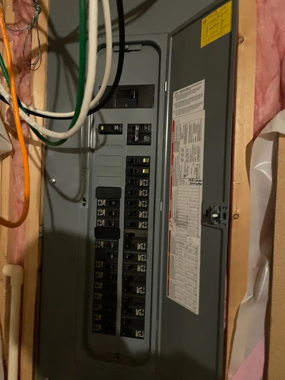 Filled-out circuit directory card inside a new panel door