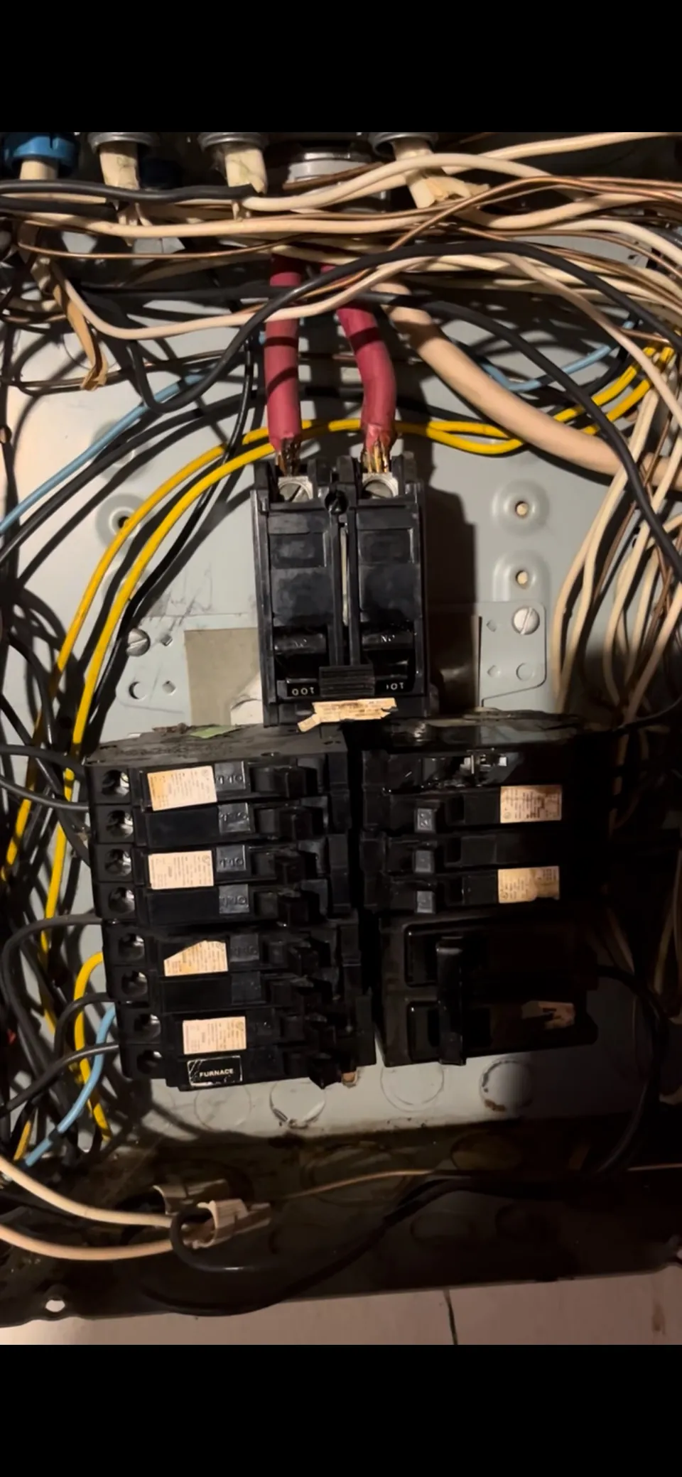 Close view of an old panel with double-tapped breakers